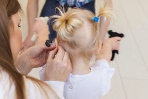 Baby girl wearing a hearing aid. Disabled child, disability and deafness concept