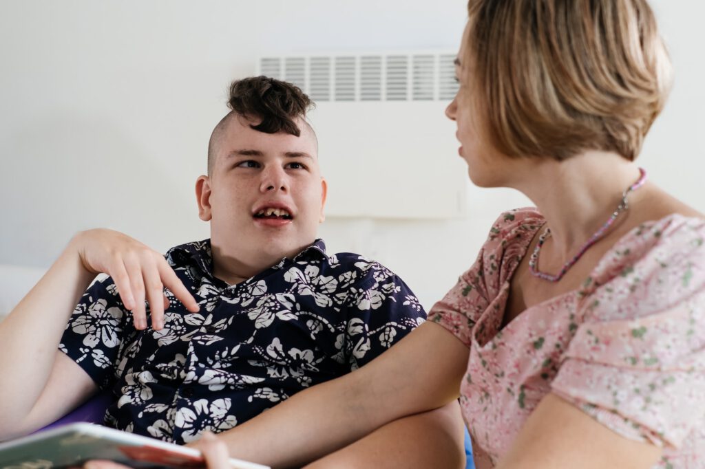 disabled child reading book, communicating, rehabilitation